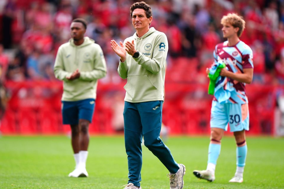 Brentford manager Keith Andrews (centre) and players applaud the fans after the final whistle following defeat in the Premier League match at the City Ground, Nottingham